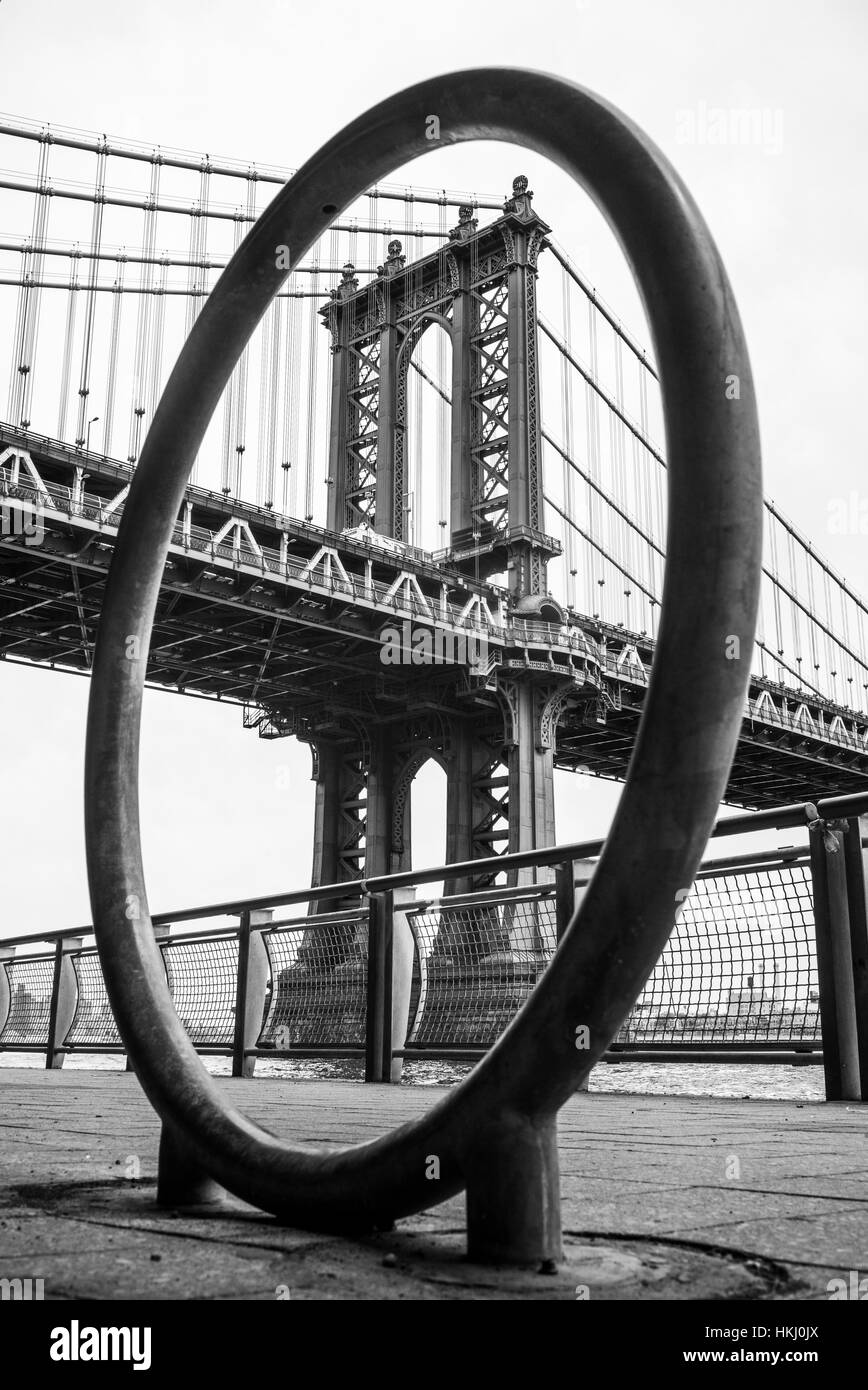 Manhattan bridge viewed through a circular structure on the promenade; New York City, New York, United States of America Stock Photo