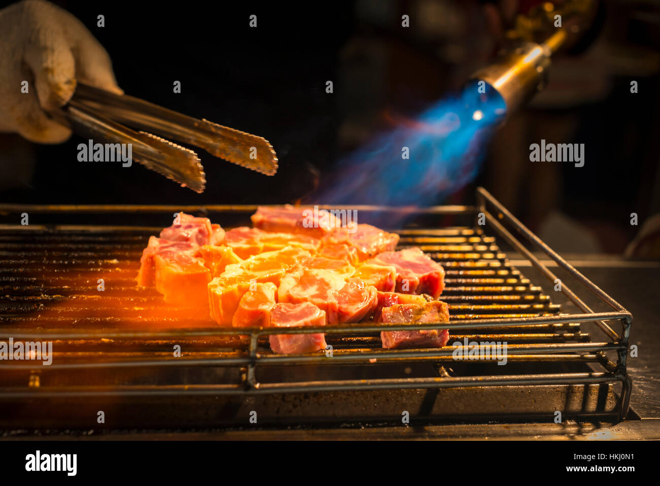 Local night markets of Taipei are really famous because of it's delicious food. grilled beef flared by blowtorch; Taiwan, China Stock Photo
