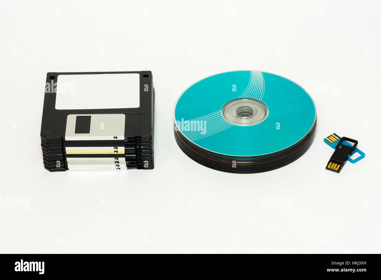 On a white background are Floppy, CD / DVD disk and USB flash Stock Photo