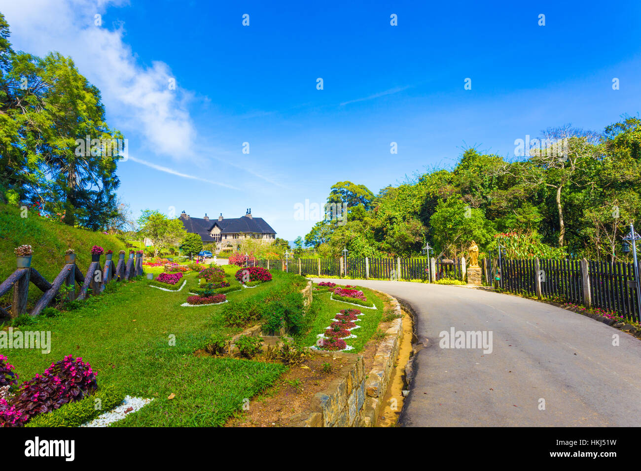 Beautifully landscaped driveway leading to Adisham or Saint Benedict Monastery on a sunny, blue sky day in Haputale, Sri Lanka Stock Photo