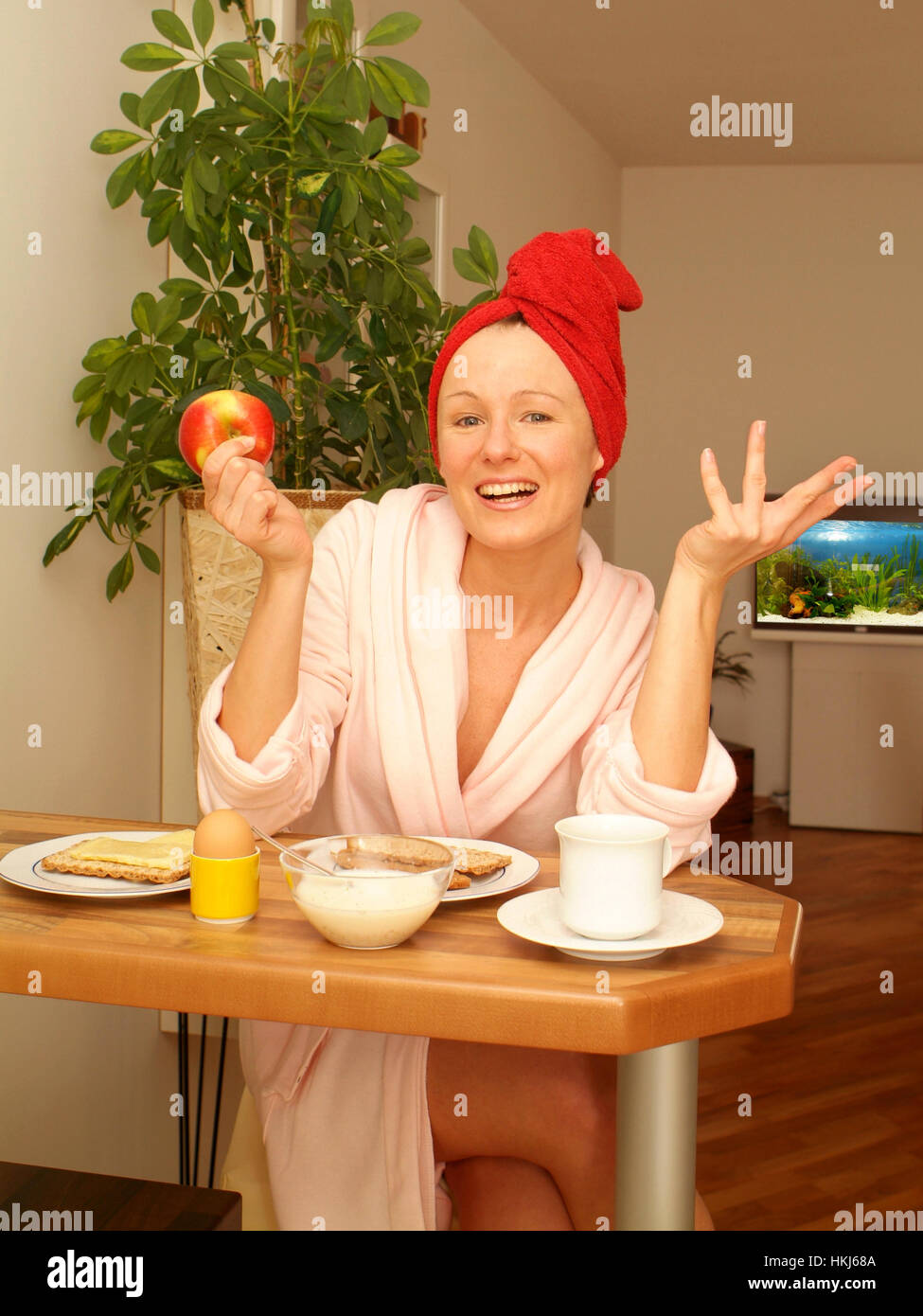 Young woman at substantial breakfast Stock Photo