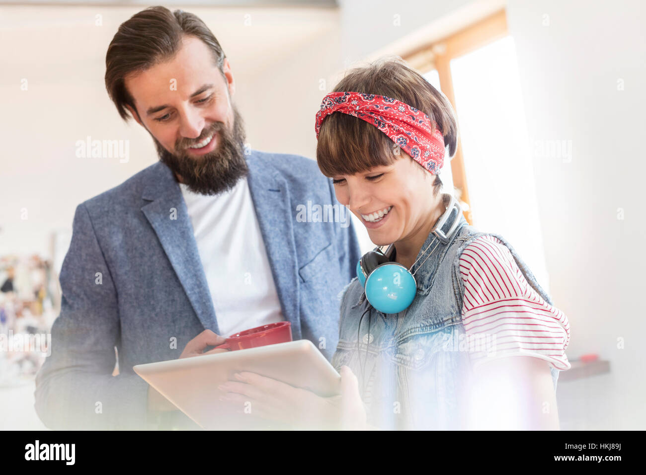 Smiling design professionals using digital tablet in office Stock Photo