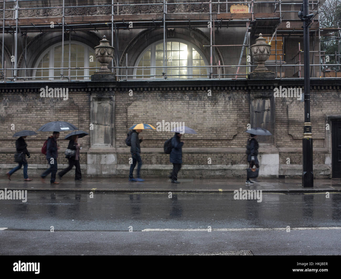 Rushing to work in the rain Stock Photo Alamy