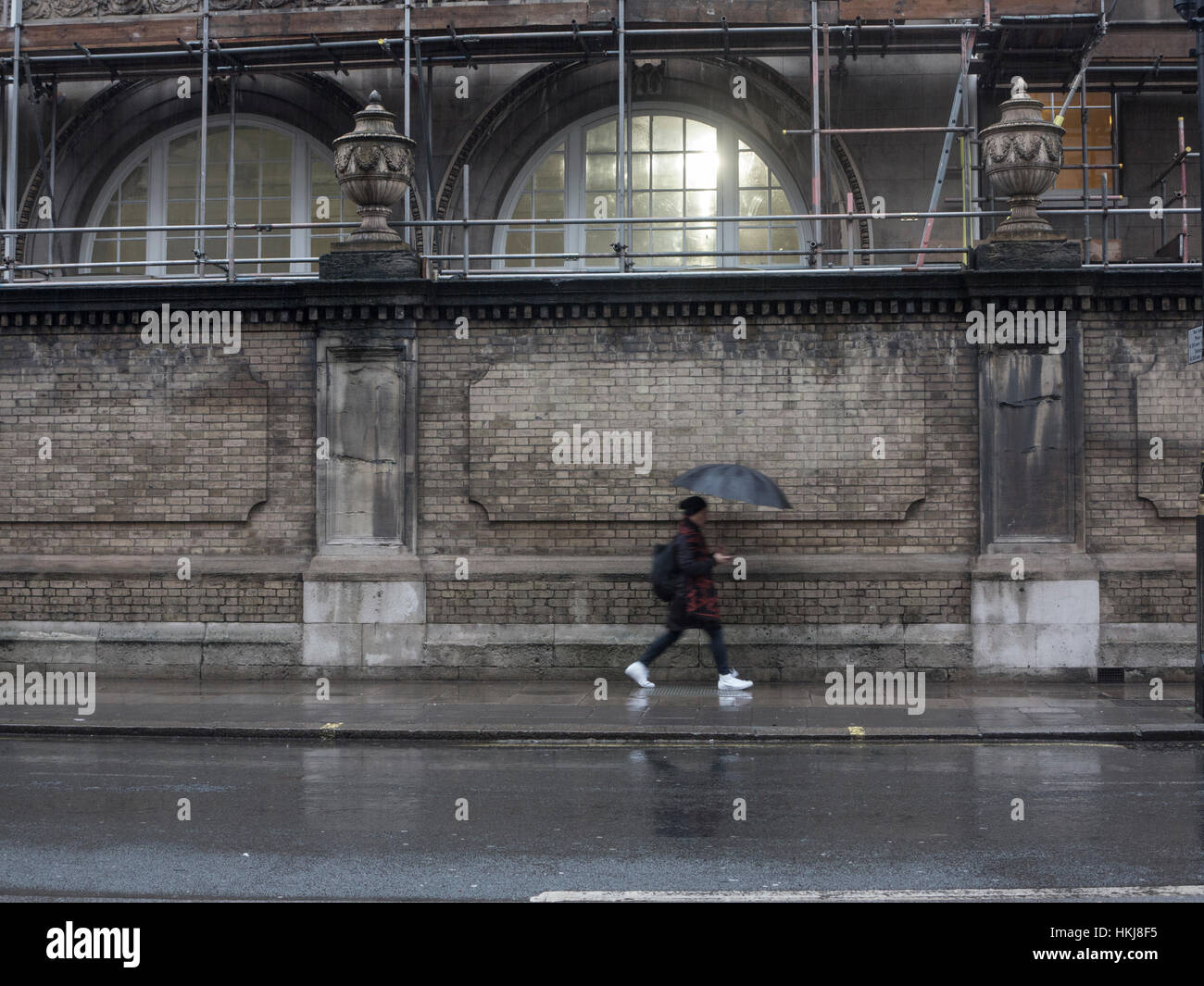 Rushing to work in the rain Stock Photo Alamy