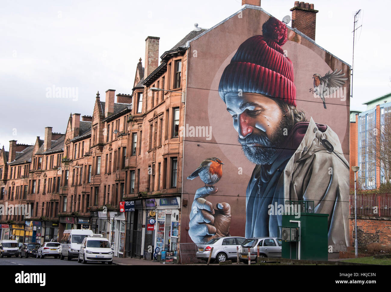 Spectacular Mural on gable end in High street Glasgow. The mural depicts a modern day St Mungo - Patron Saint of Glasgow. Stock Photo