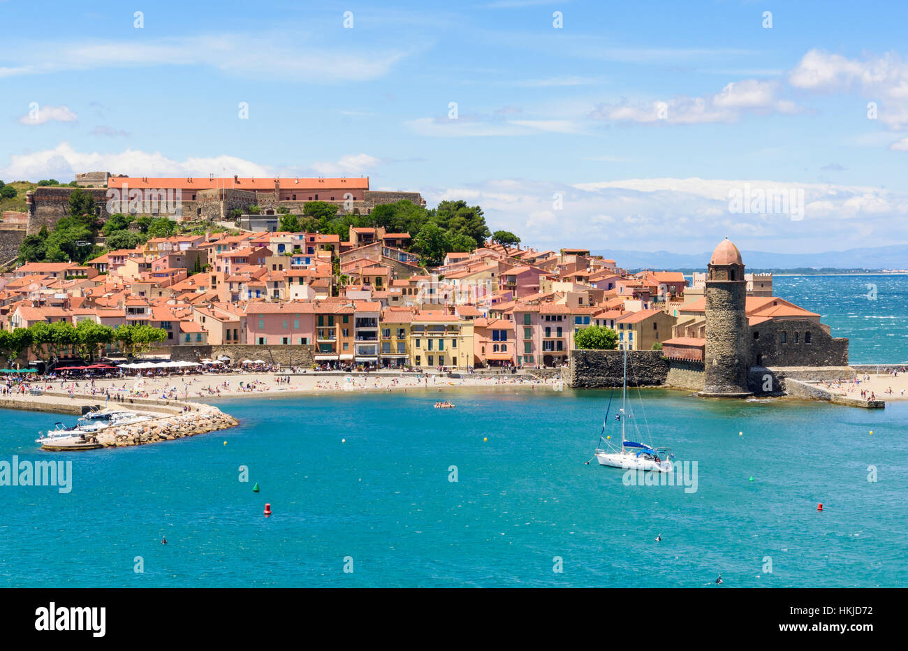 Collioure old town and landmark bell tower of Notre Dame des Anges and yacht moored in the bay, Collioure, Côte Vermeille, France Stock Photo