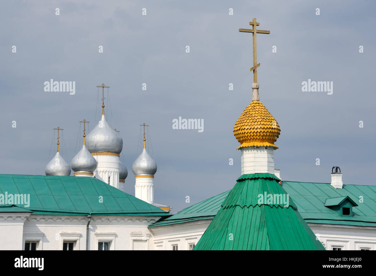 = Bright Beauty Against the Grey Sky =  A view of the green roofs of monastic buildings and cupolas with crosses on the grounds of Spaso-Yakovlevsky m Stock Photo