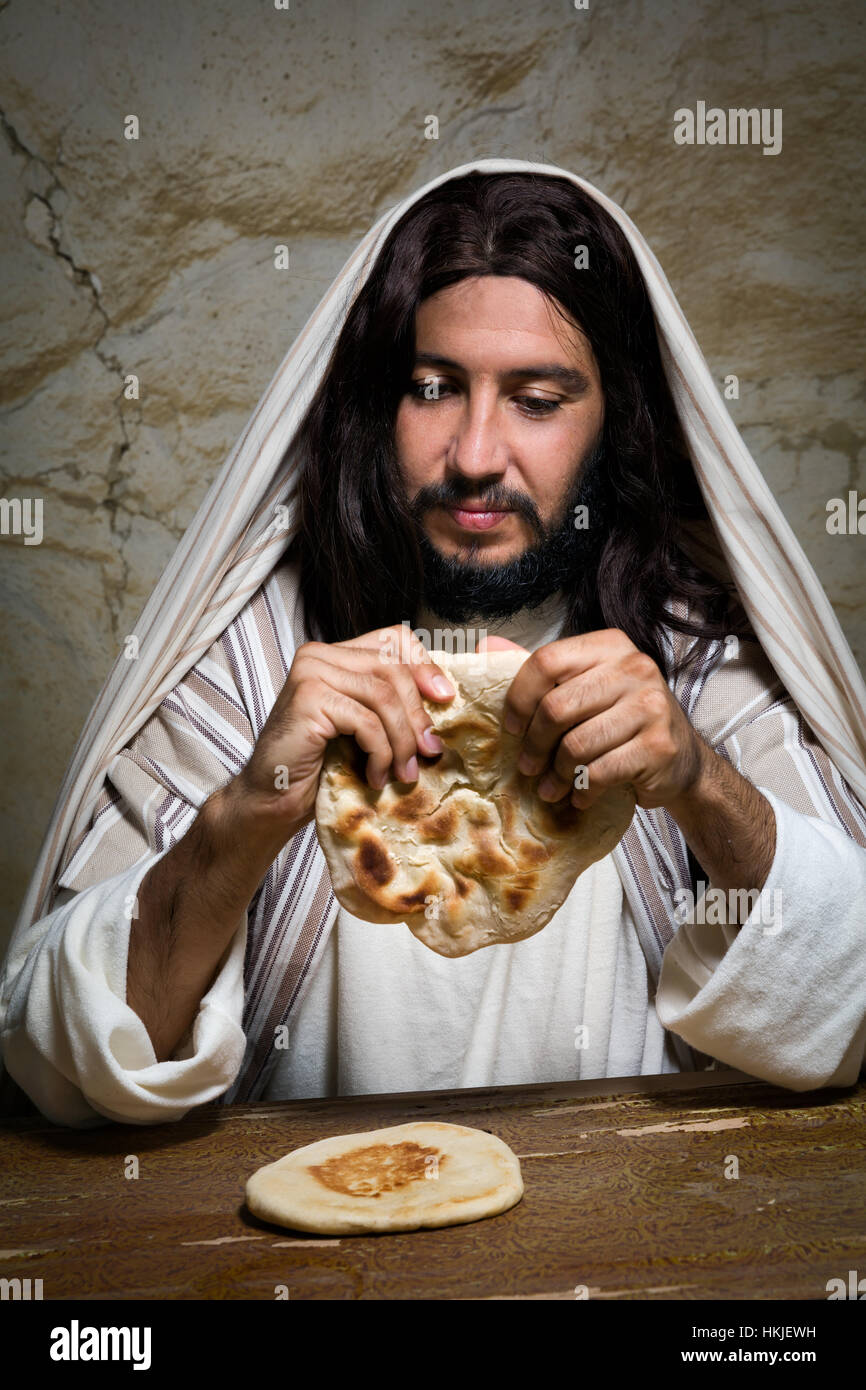 Authentic reenactment scene of Jesus breaking the bread during Last Supper, saying 'this is my body'. Stock Photo