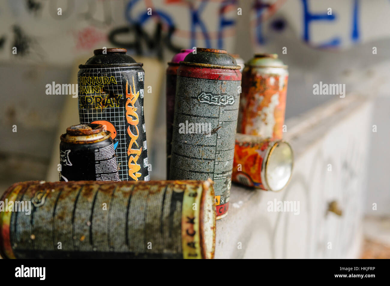 Empty aerosol cans discarded after being used to spray graffiti Stock Photo