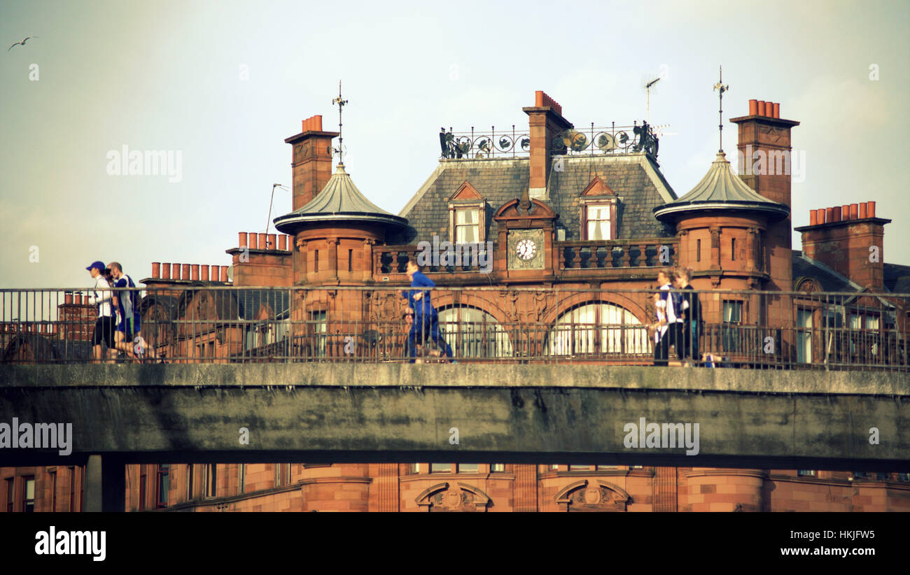 people on the pedestrian bridge at  St. George’s Mansions at charing cross and sauchiehall street Glasgow Stock Photo