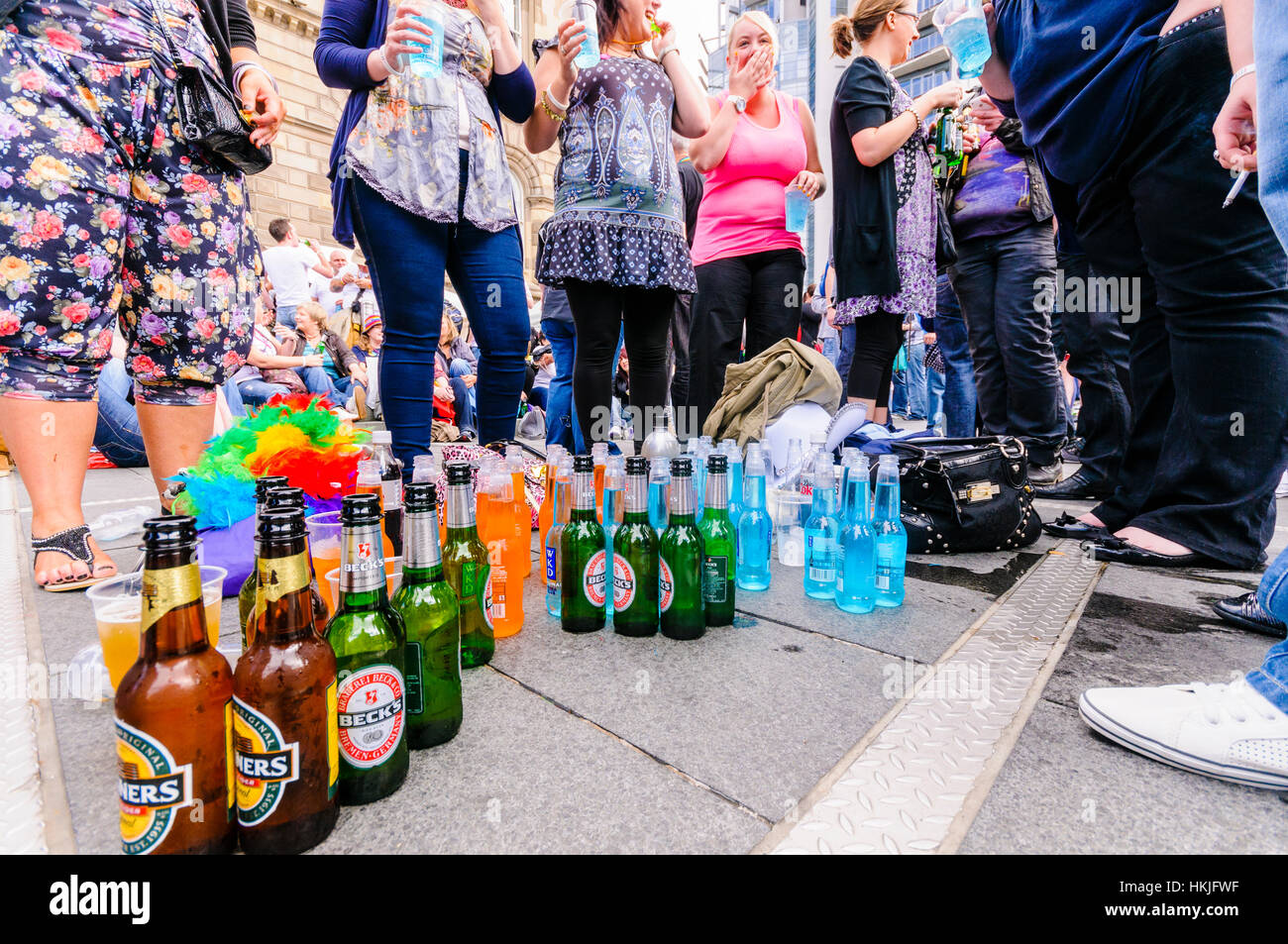 Large quantity of alcohol including Magners cider, Becks lager and WKD on the footpath with a crowd of people. Stock Photo