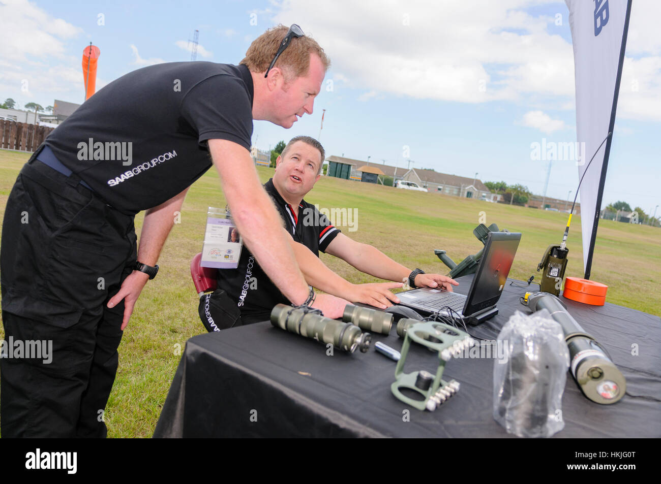 Two Saab engineers examine data on a laptop computer at a military training exercise Stock Photo