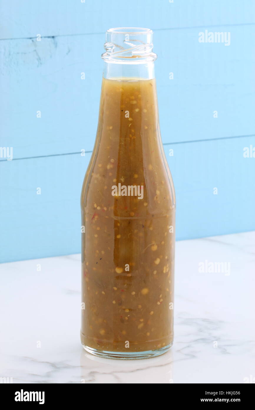 Artisan mexican tomatillo sauce on retro vintage carrara marble setting, with a spicey mild hot flavor perfect for all your Mexican, tex-mex recipes a Stock Photo