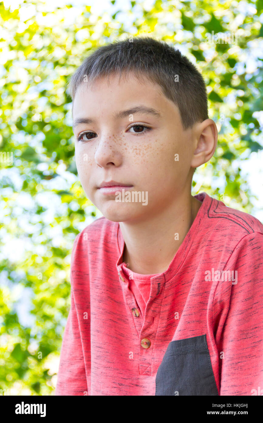Portrait of cute freckles boy with dark brown eyes Stock Photo