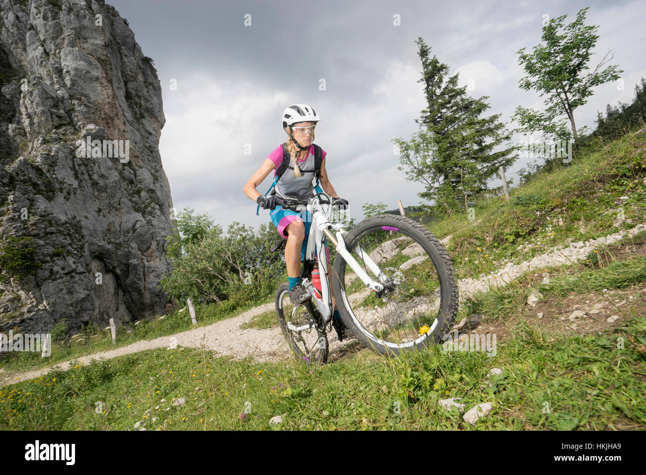 Mountain biker riding on uphill, Kampenwand, Bavaria, Germany Stock Photo