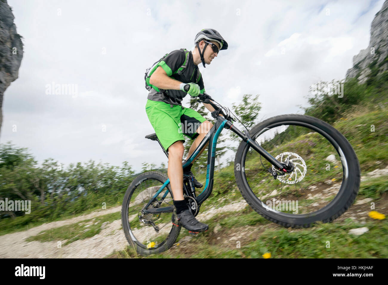 Mountain biker riding on uphill, Kampenwand, Bavaria, Germany Stock Photo