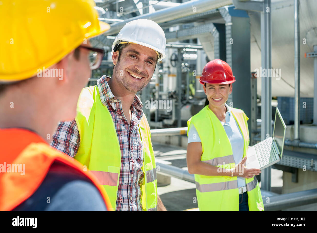 Happy engineer with his colleagues in meeting with laptop at geothermal ...