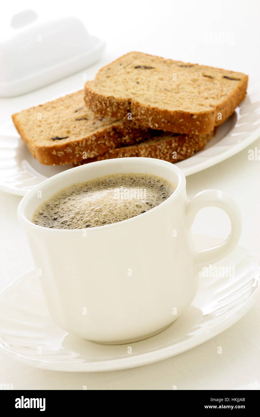 delicious breakfast with fresh hot coffee, butter and whole grain bread. Stock Photo