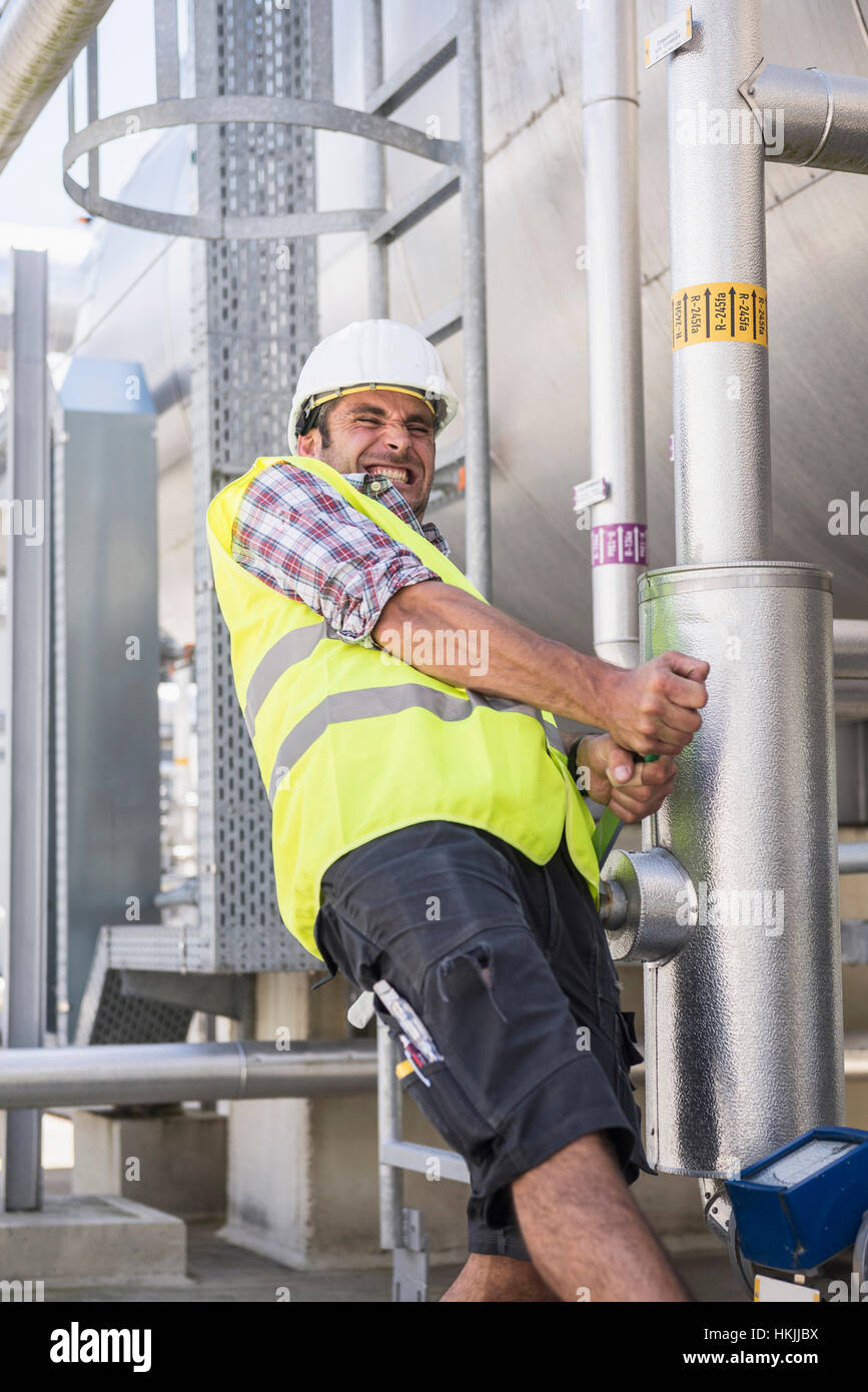 Male engineer pulling lever in Geothermal Power Station, Bavaria