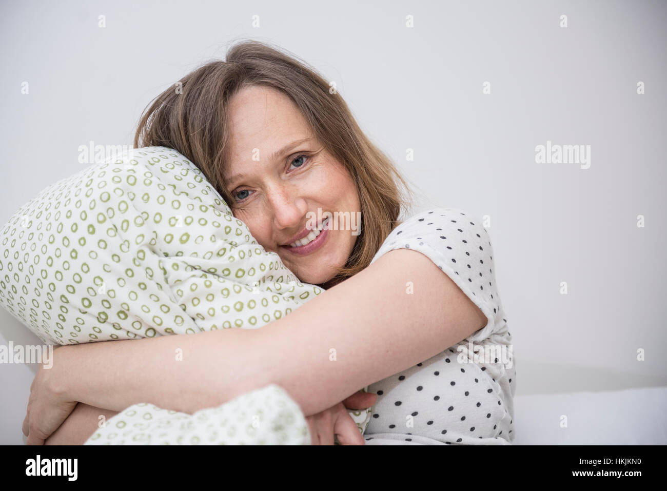 Happy Pregnant Woman Cuddling Her Pillow In Bed Munich Bavaria
