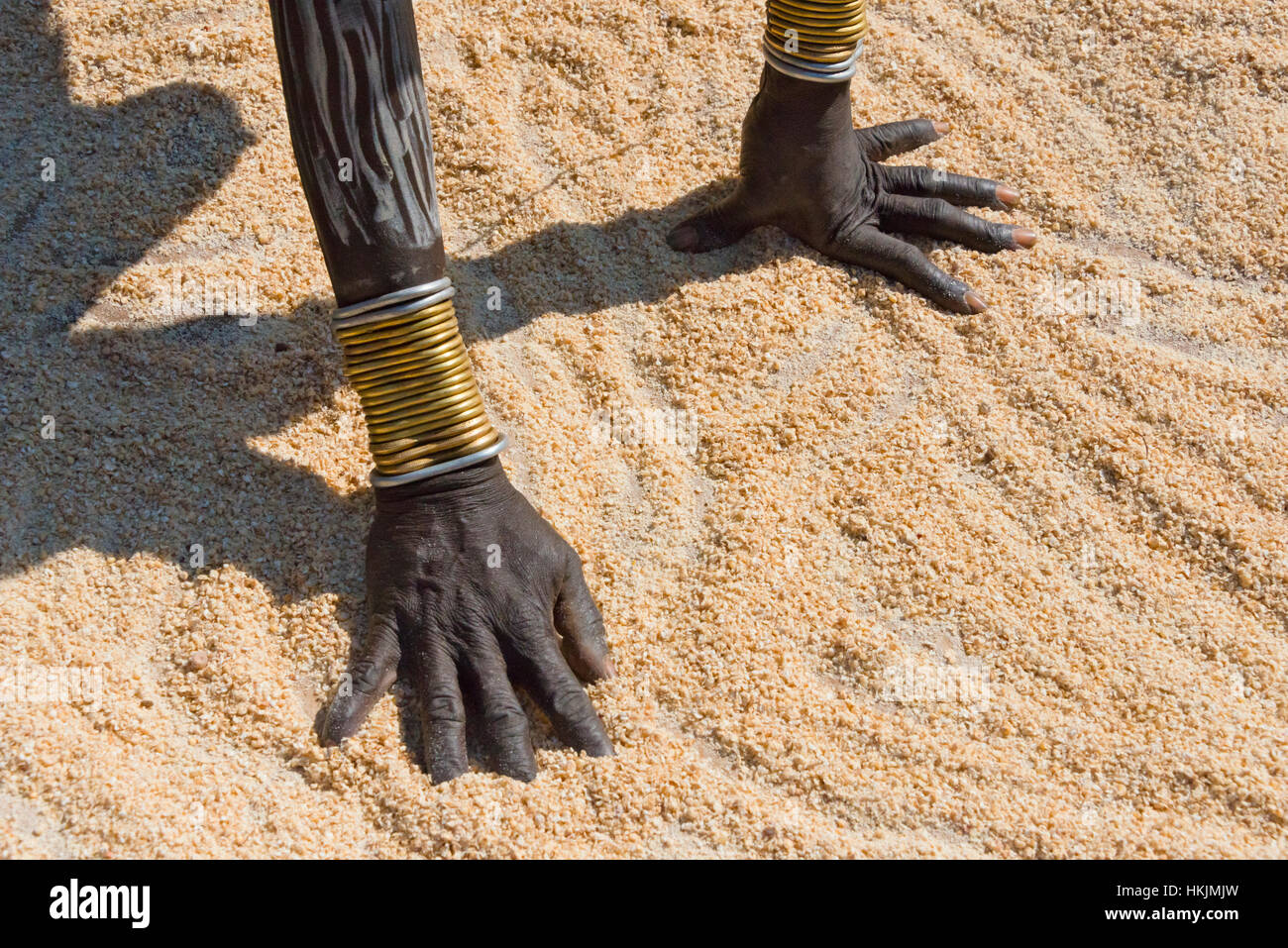 Mursi tribe people in traditional clothing wearing bracelets, Mursi Village, South Omo, Ethiopia Stock Photo