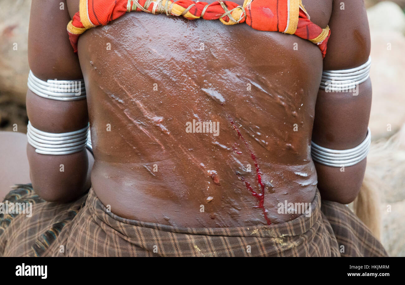 Hamar tribe woman with whip slashes on the back at Cattle Jumping, Hamar Village, South Omo, Ethiopia Stock Photo