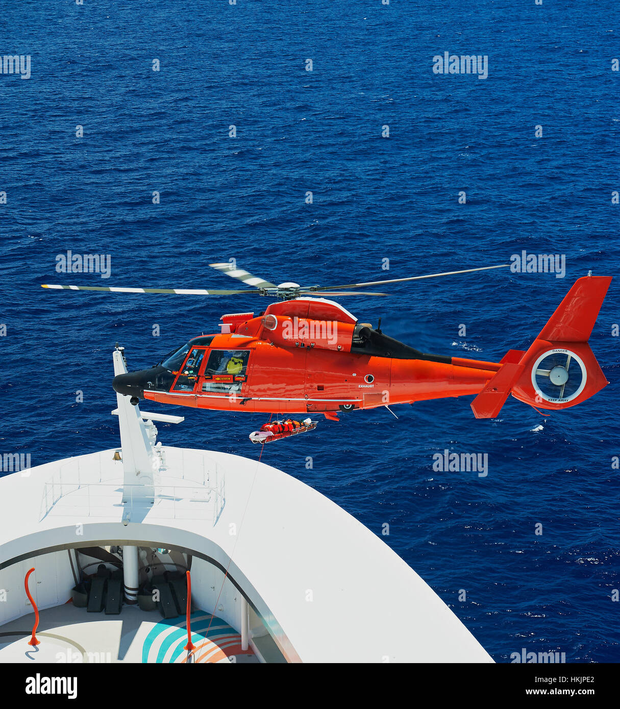 lifting person on rescue helicopter from ship at sea Stock Photo