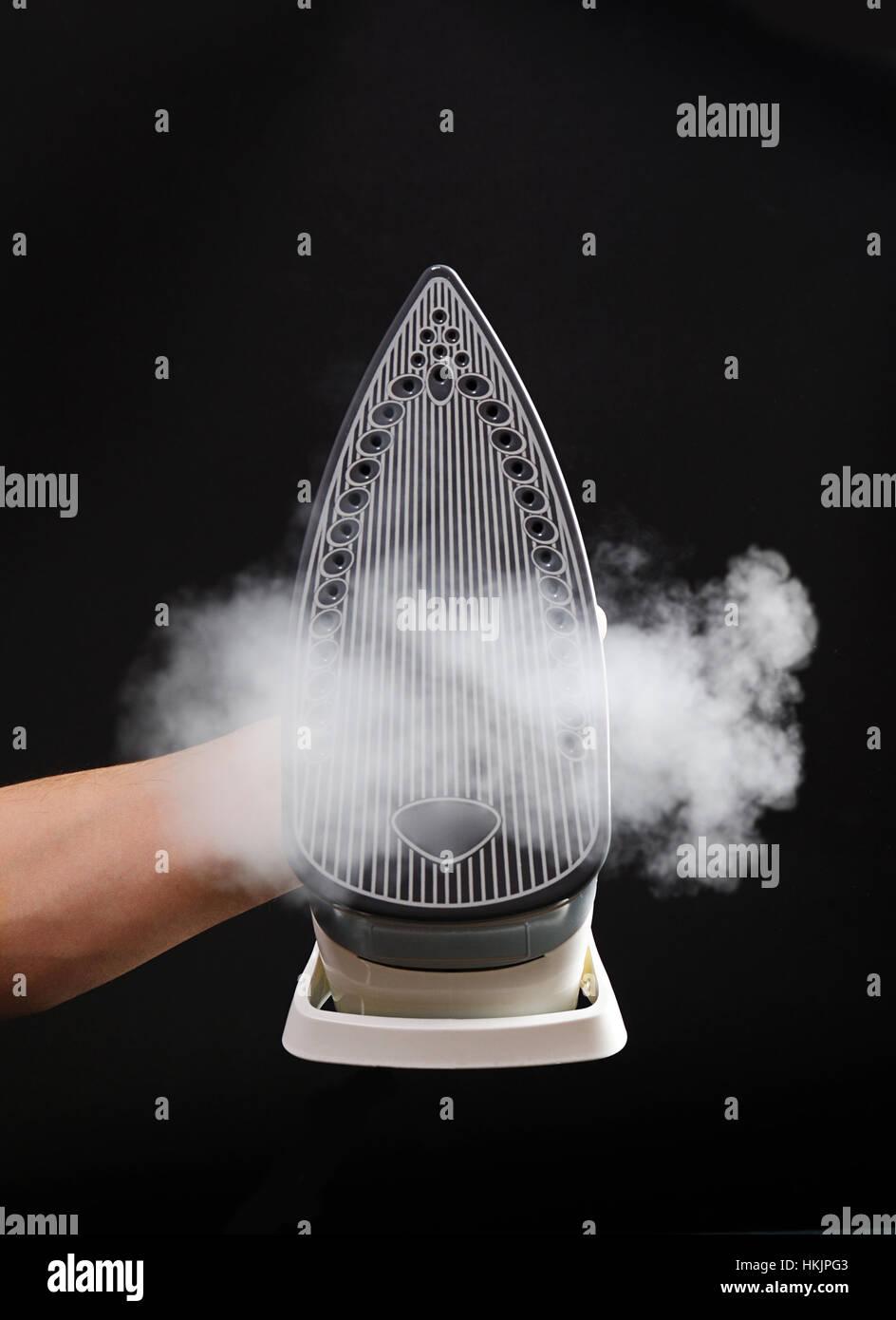 Bottom of iron with steam on black isolated Stock Photo Alamy