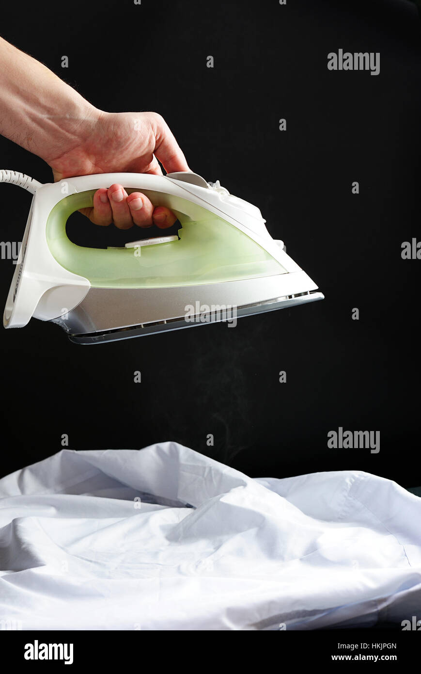 ironing white shirt on black background isolated Stock Photo Alamy