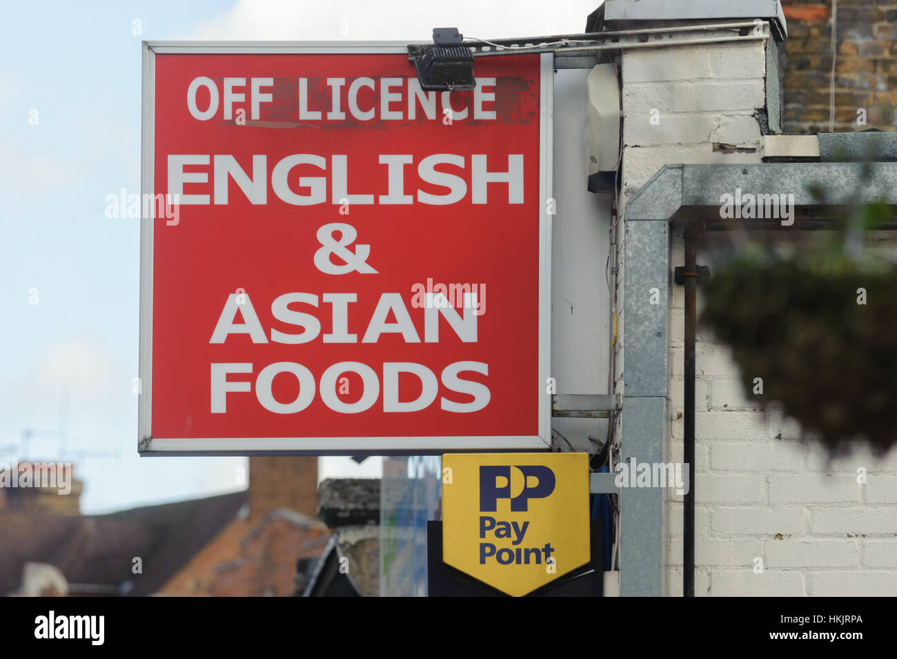 Shop sign for Off Licence selling English and Asian Foods. Hayes, Middlesex, UK Stock Photo