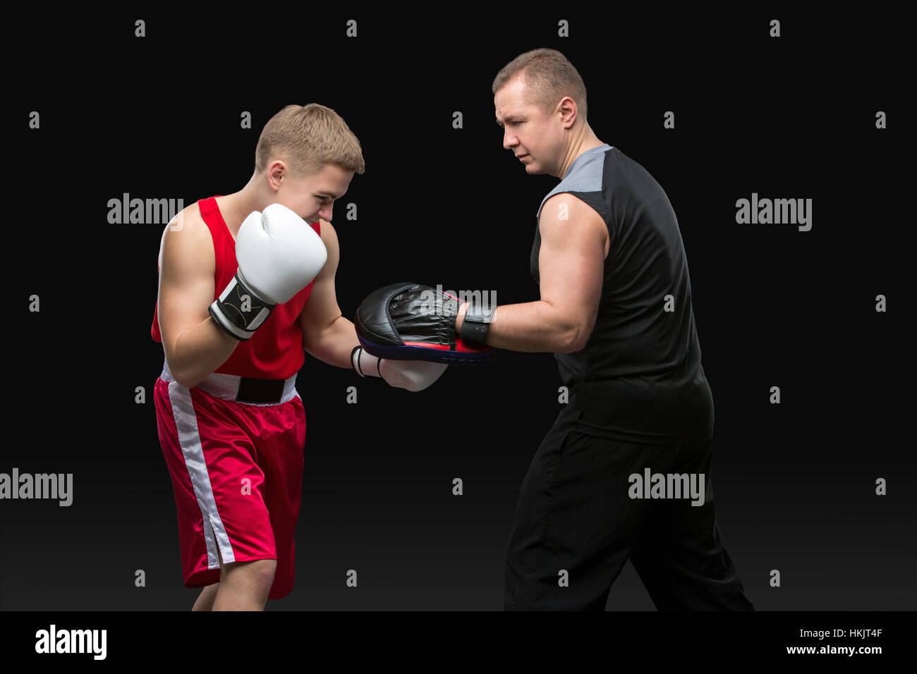 Young boxer working out with coach Stock Photo - Alamy