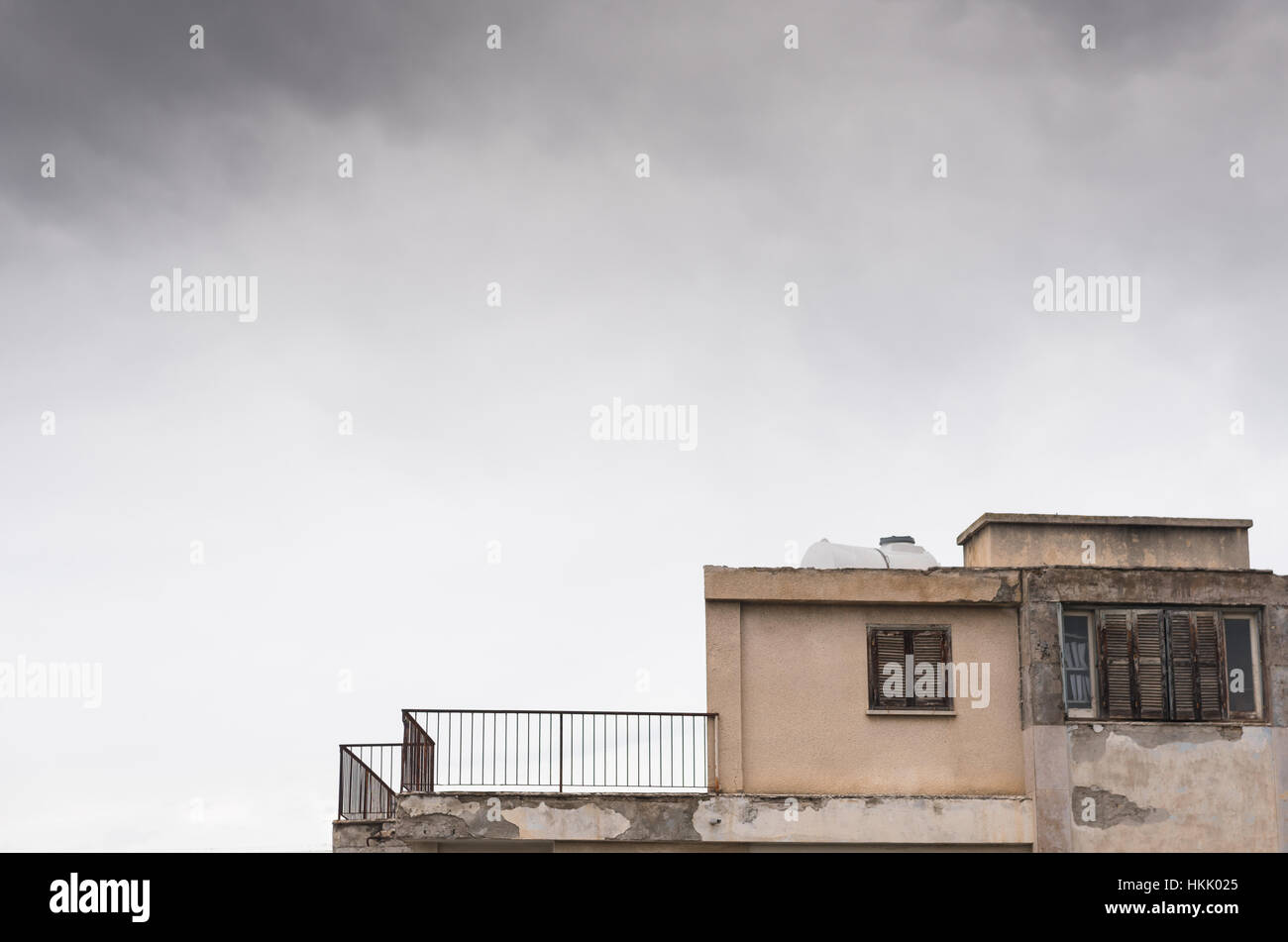 Apartment house in a very bad condition and cloudy overcast sky Stock Photo