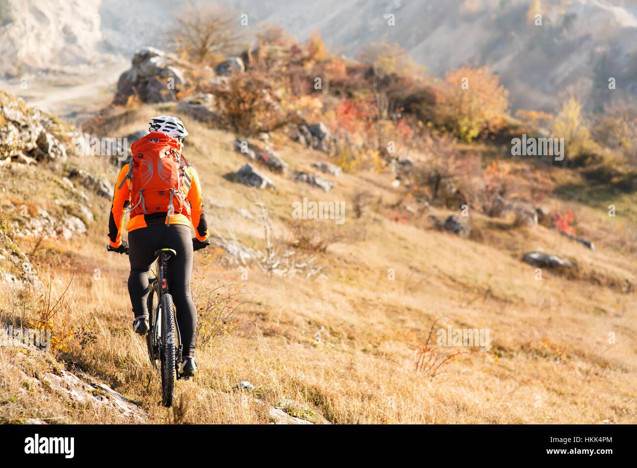 Bike cyclist with red backpack riding single track Stock Photo - Alamy