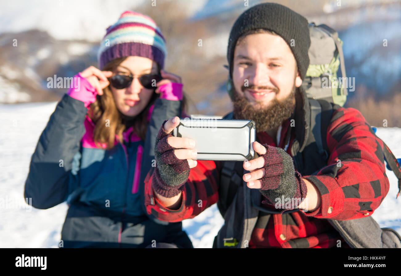 Couple taking selfie on a winter hiking trip Stock Photo