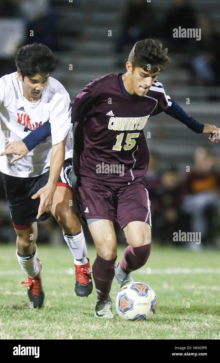 Florida, USA. 28th Jan, 2017. Countryside mid fielder Kyle Frudakis (15) dribbles the ball as Northeast's Omar Stuart (77) defends during the second half of the Class 4A, District 10 boys soccer final at St. Petersburg High School in St. Petersburg, Florida. Credit: Charlie Kaijo/Tampa Bay Times/ZUMA Wire/Alamy Live News Stock Photo