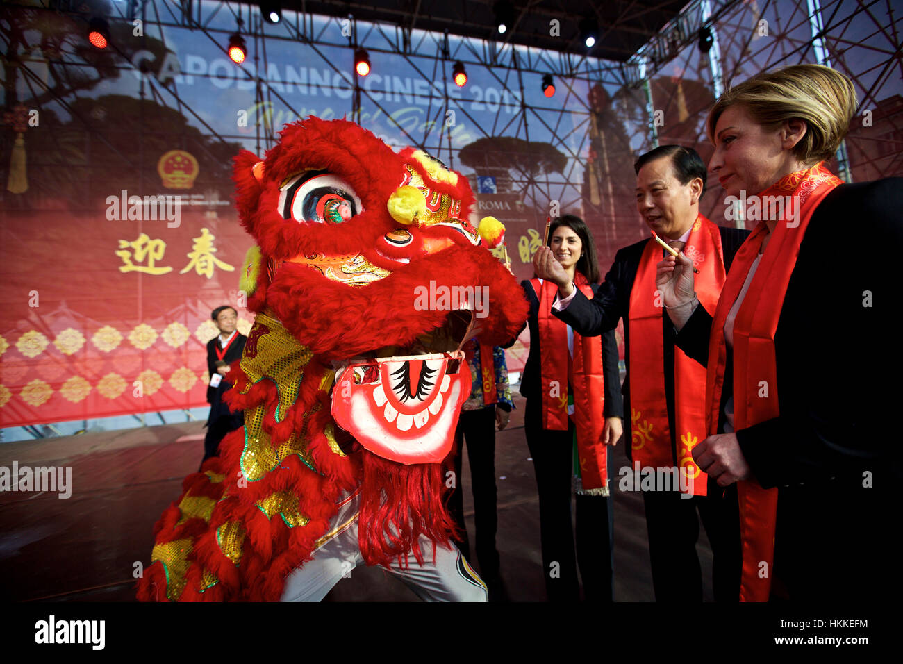 Rome, Italy. 28th Jan, 2017. Chinese ambassador to Italy Li Ruiyu (2nd R), Rome Mayor Virginia Raggi (3rd R) and Italian tourism undersecretary Dorina Bianchi (1st R) paint the eyes of the dancing lion to celebrate the Chinese Lunar New Year in downtown Rome, Italy, Jan. 28, 2017. Credit: Jin Yu/Xinhua/Alamy Live News Stock Photo
