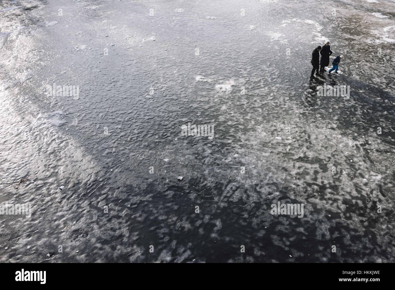 Berlin, Berlin, Germany. 29th Jan, 2017. People walk on a frozen lake in Schoeneberg. Due to the cold temperatures in January, a thin layer of ice has formed on the Berlin waters. Berlin Police say the ice on many lakes and rivers in the area is not safe to be on. Credit: Jan Scheunert/ZUMA Wire/Alamy Live News Stock Photo