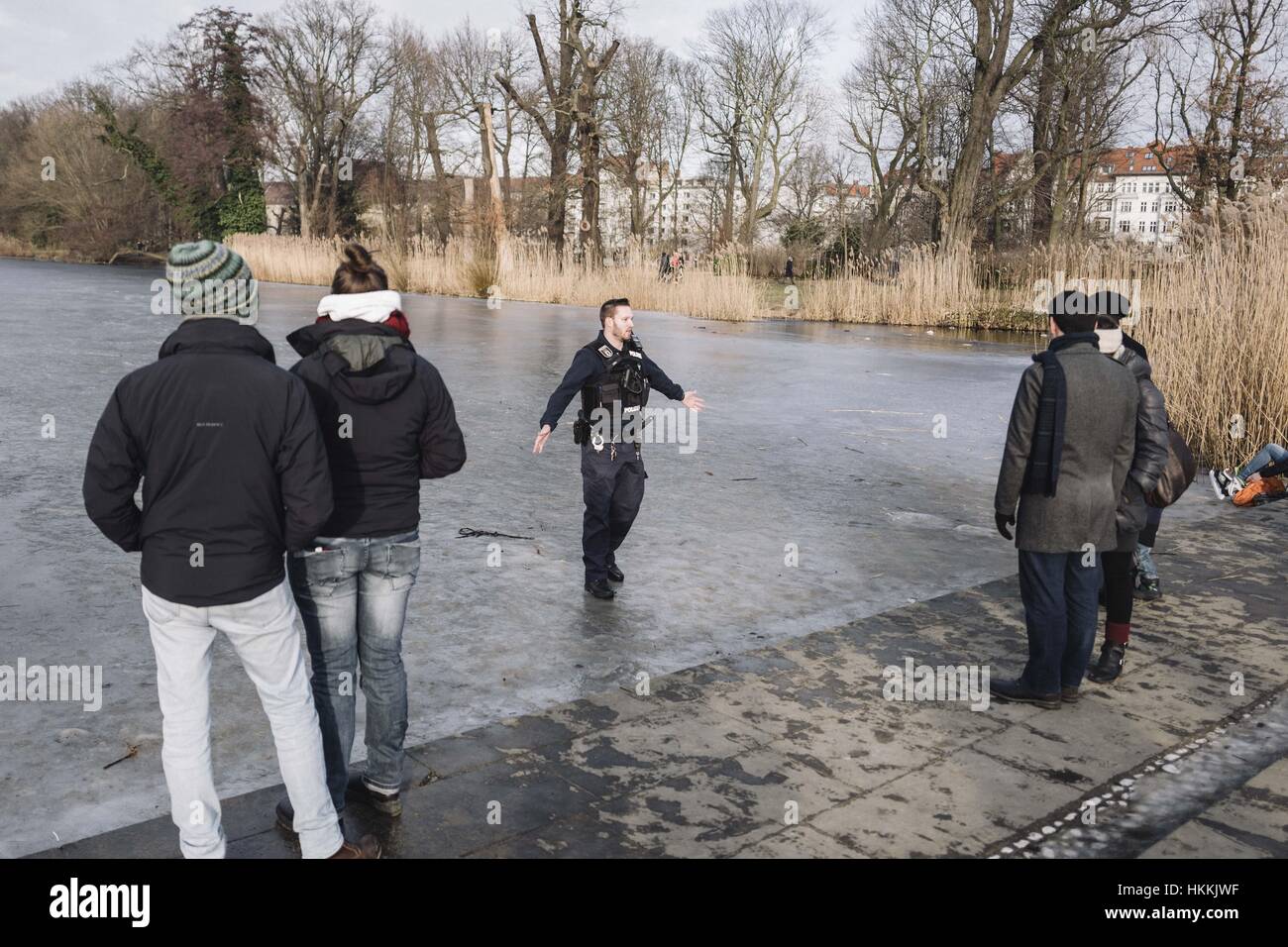 Berlin, Berlin, Germany. 29th Jan, 2017. A Policeman disperse people from a frozen lake next to Charlottenburg Palace. Due to the cold temperatures in January, a thin layer of ice has formed on the Berlin waters. Berlin Police say the ice on many lakes and rivers in the area is not safe to be on. Credit: Jan Scheunert/ZUMA Wire/Alamy Live News Stock Photo