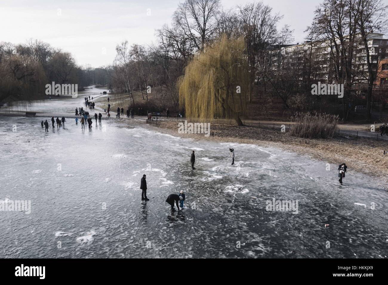 Berlin, Berlin, Germany. 29th Jan, 2017. People walk on a frozen lake in Schoeneberg. Due to the cold temperatures in January, a thin layer of ice has formed on the Berlin waters. Berlin Police say the ice on many lakes and rivers in the area is not safe to be on. Credit: Jan Scheunert/ZUMA Wire/Alamy Live News Stock Photo