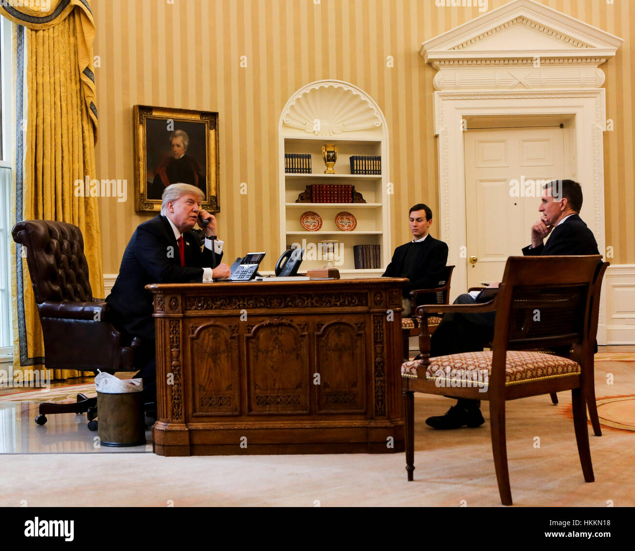 Washington, USA. 29th January, 2017. US President Donald Trump speaks on the phone with the King of Saudi Arabia, Salman bin Abd al-Aziz Al Saud in the Oval Office of the White House, surrounded by Senior Adviser to the President Jared Kushner (C), and Security Advisor Michael Flynn (R). Credit: Aude Guerrucci/Pool via CNP/MediaPunch/Alamy Live News Stock Photo
