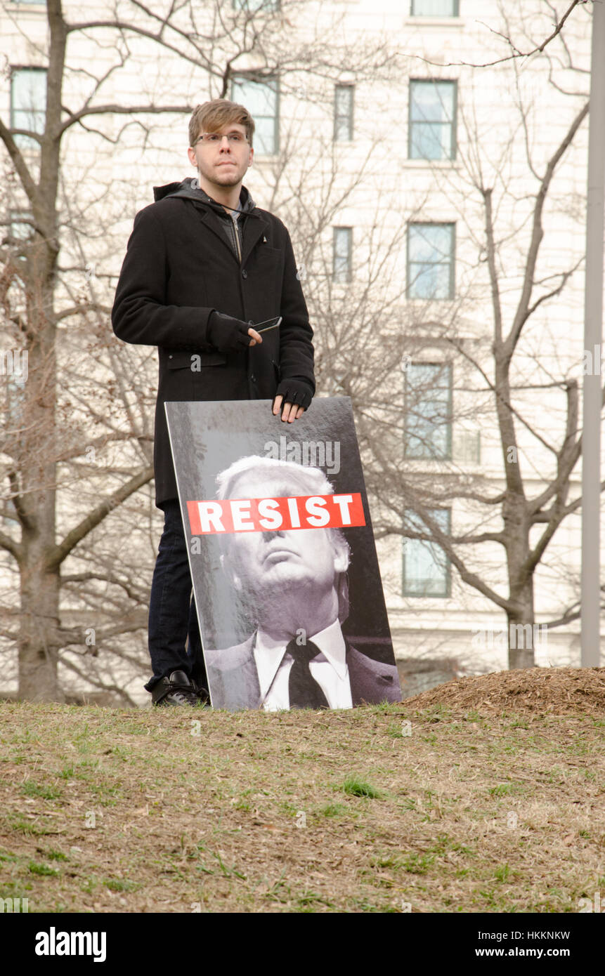 Washington, USA. 29th Jan, 2017. Young man holds image of Donald Trump with Resist across his eyes during a protest opposing Donald Trump's immigration policies and refugee ban, in Washington D.C. Credit: Angela Drake/Alamy Live News Stock Photo