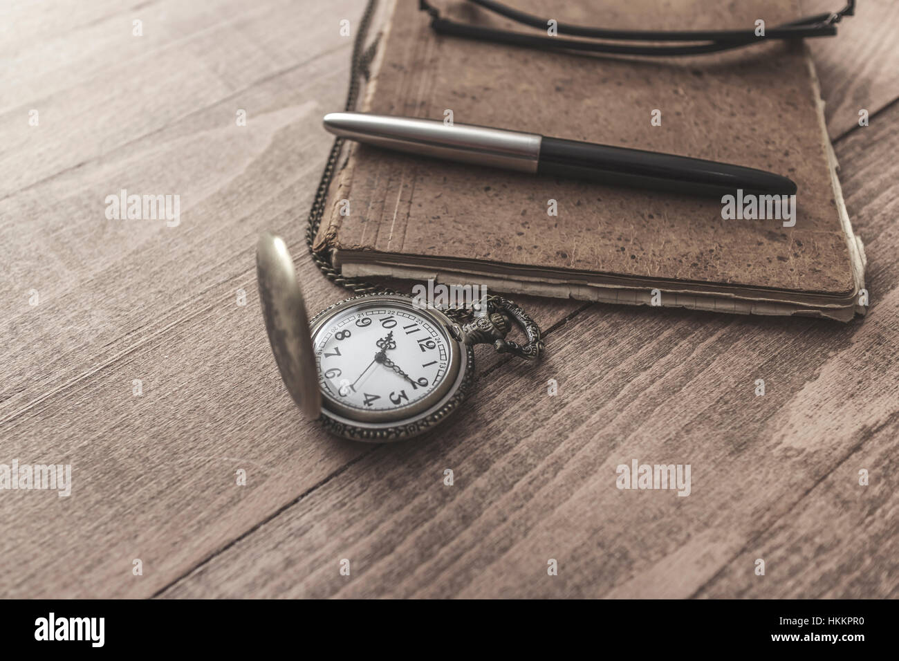 Vintage pocket  watch with pen and paper, close up Stock Photo