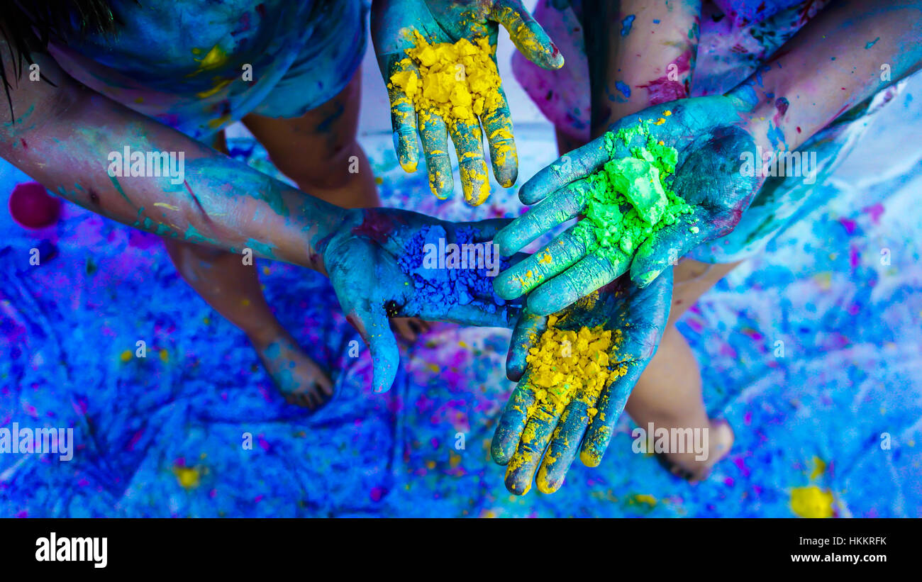 Some indian kids playing with colors Stock Photo
