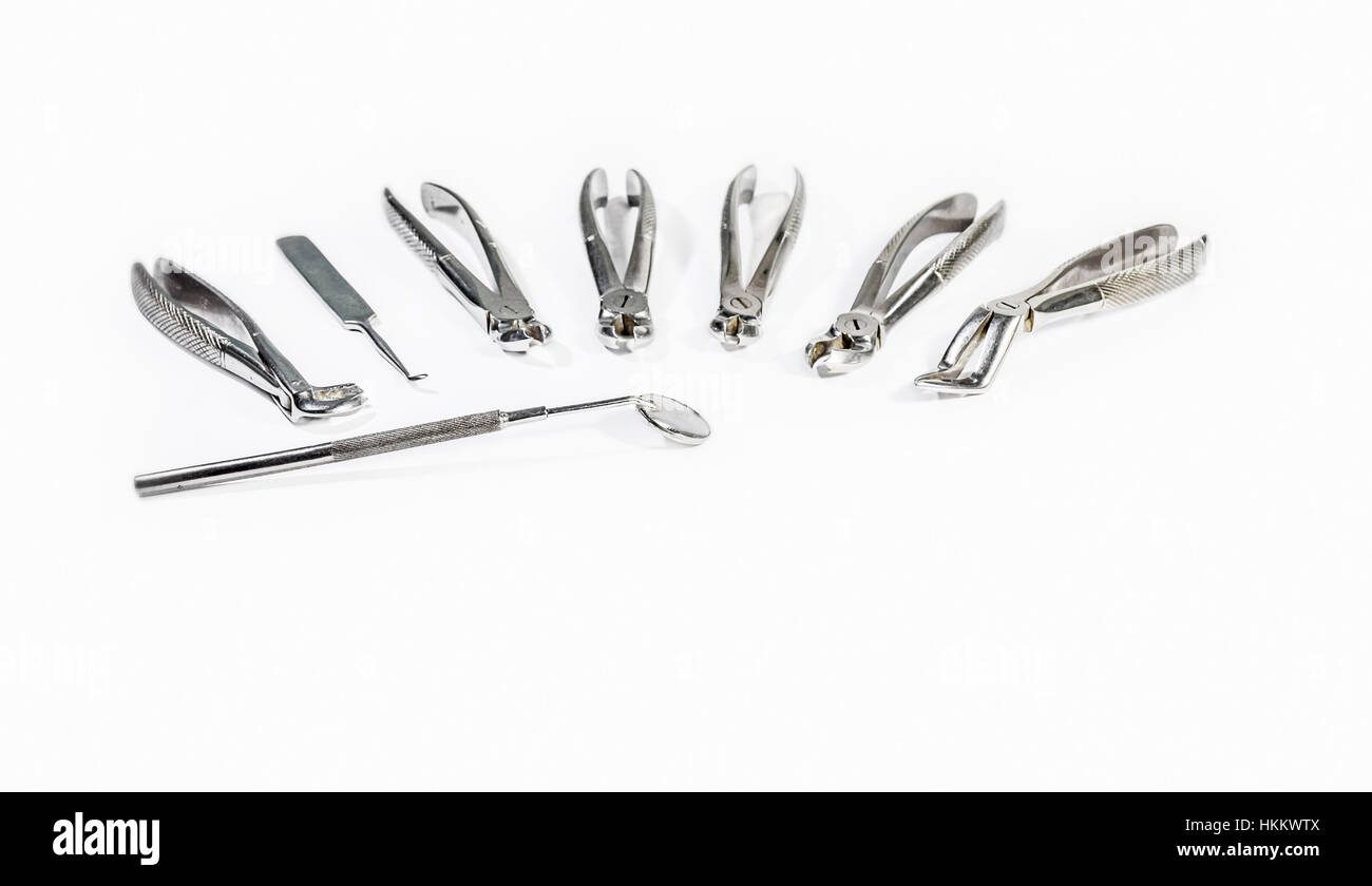 Dental Instruments arranged on white table.isolated on white.concept of