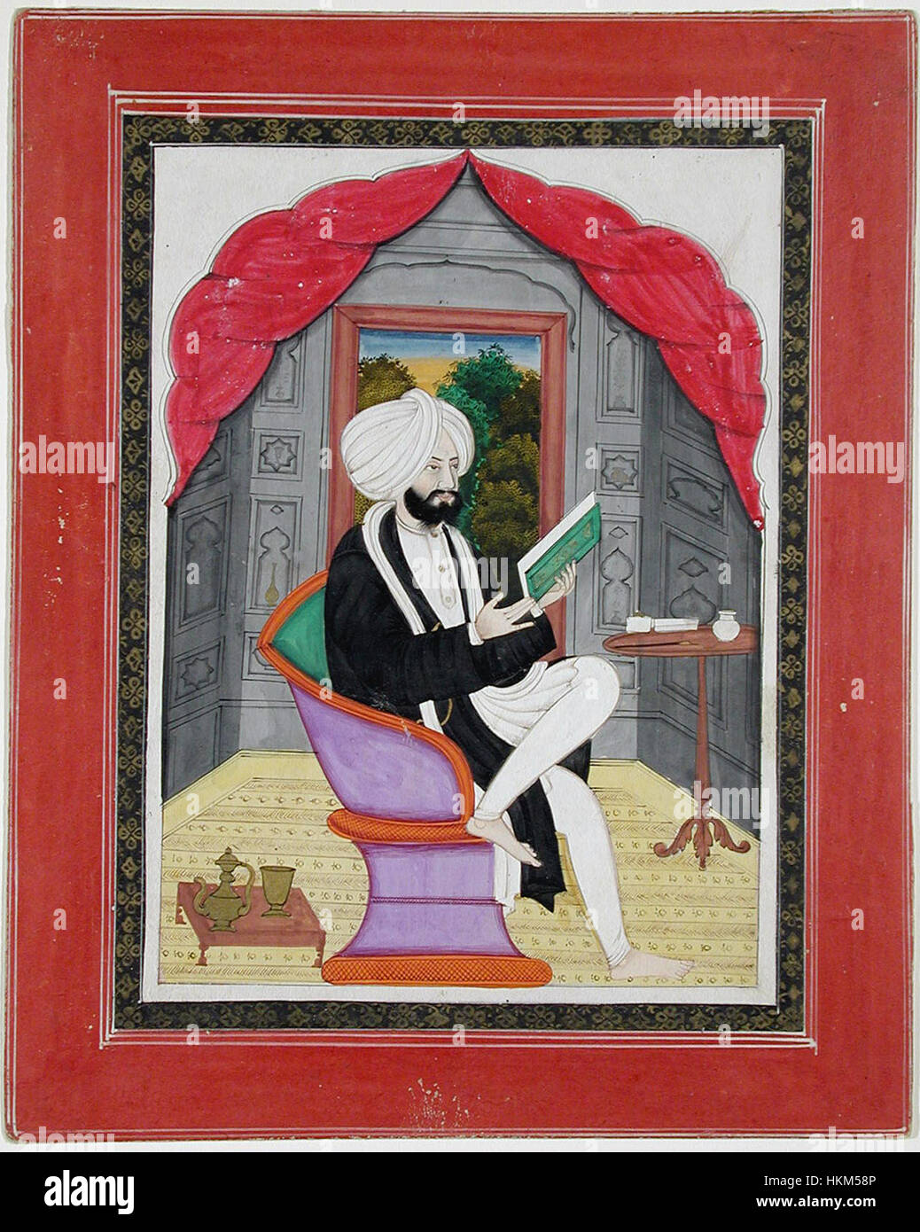 A Sikh Sardar reading from a book, seated in front of a window (6124597647) Stock Photo