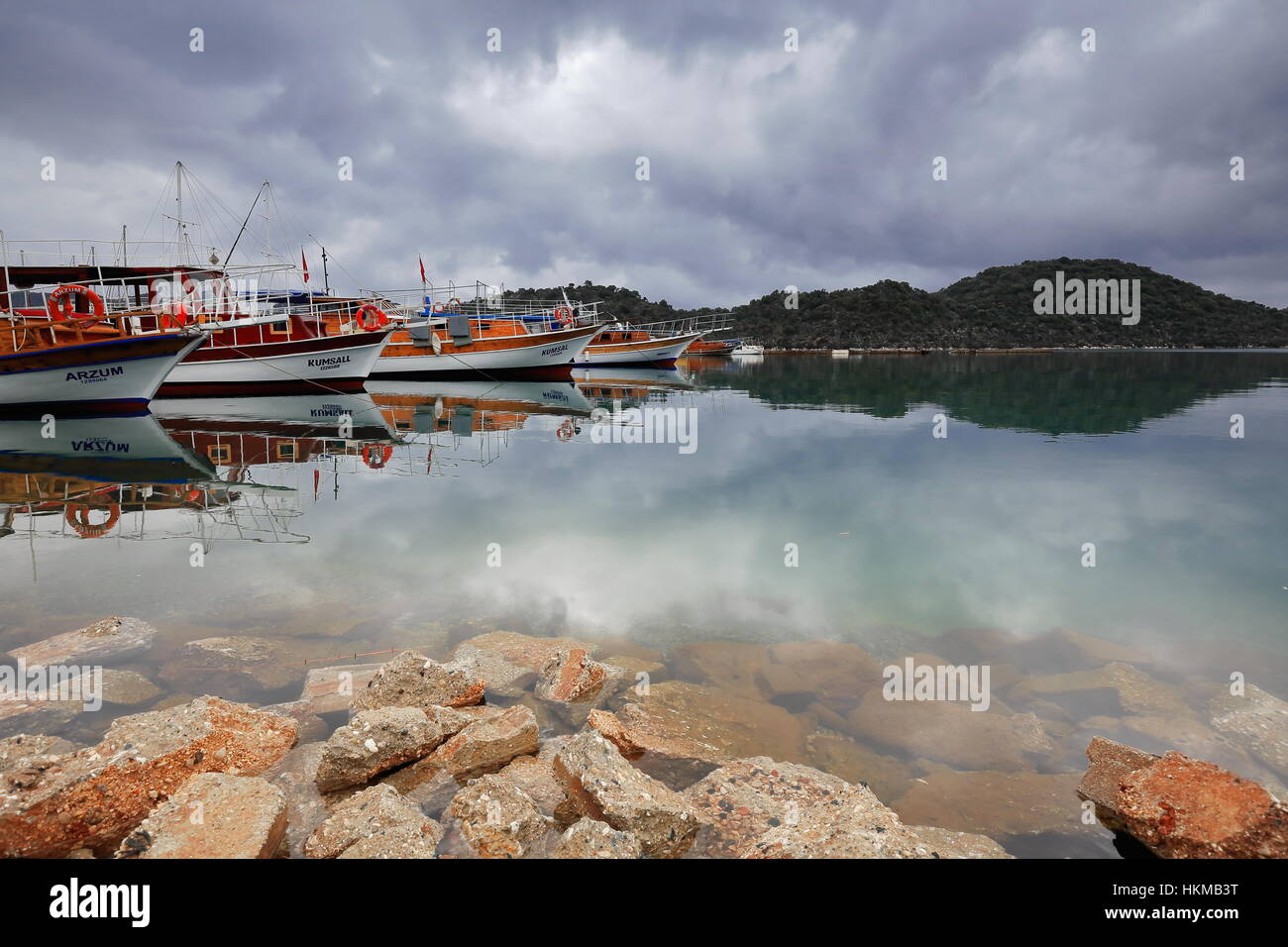 Uçagiz, Turkey-April 2, 2015: Tourist boats in the morning rest moored in the harbor while waiting for the visitors to come aboard and restart work sa Stock Photo