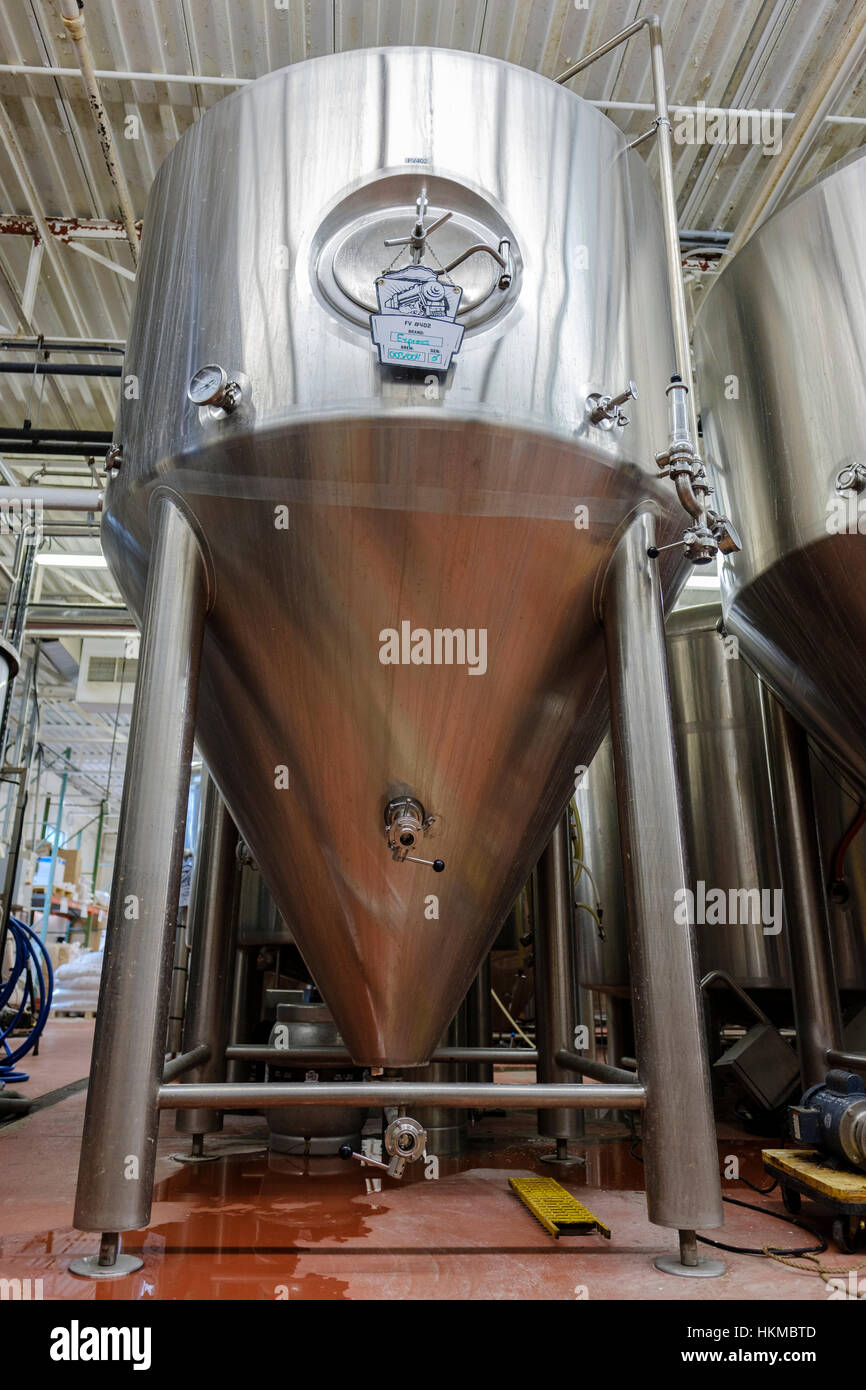 Close-up of a stainless steel commercial beer tank used for fermenting beer at Railway City Brewing Co. in St Thomas, Ontario, Canada. Stock Photo