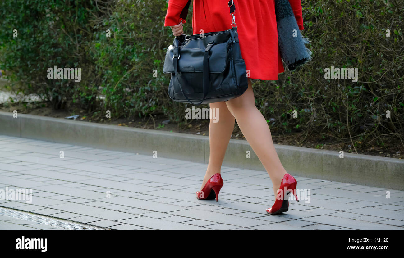 Red coat and high heals Stock Photo