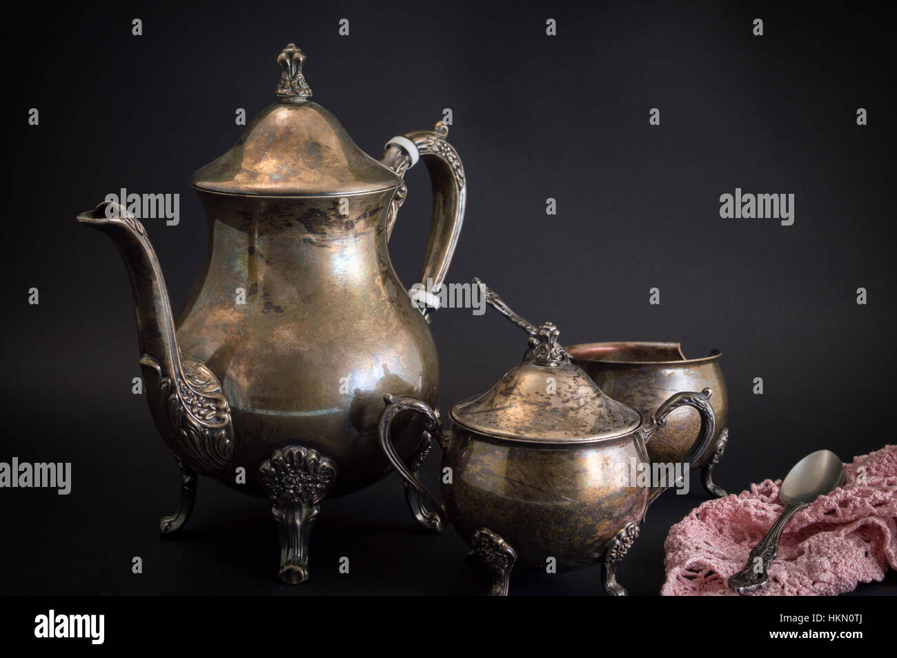 Old silver kettle utensils on black background Stock Photo