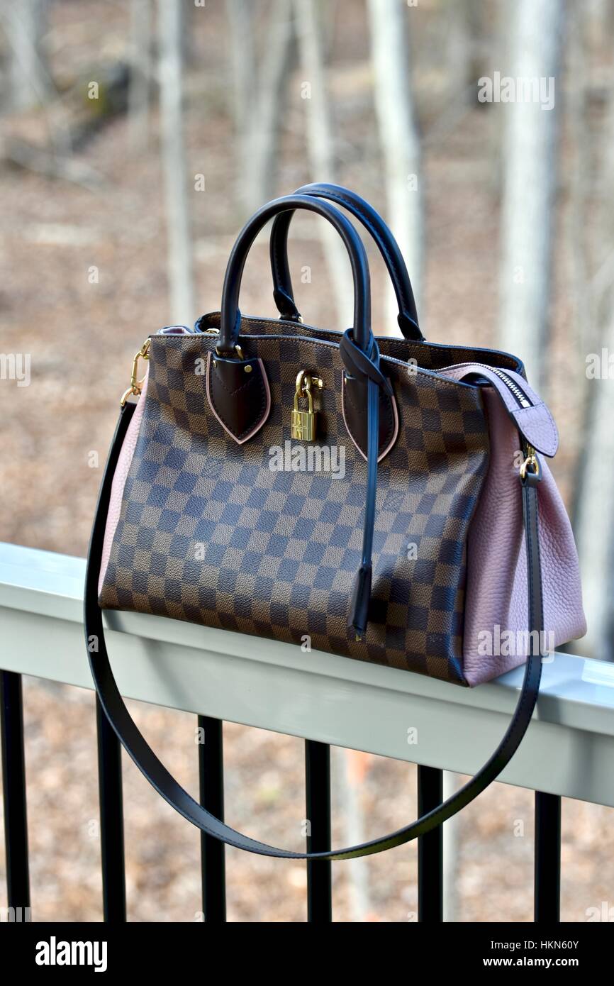 Woman with brown Louis Vuitton checkered bag on September 22, 2018 in  Milan, Italy Stock Photo